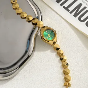 Elegant gold women's wristwatch with green dial and link strap for luxury aesthetic.