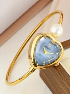 Elegant gold bangle watch with heart-shaped blue dial, pearl, and dazzling rhinestones for women.