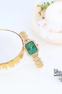 Elegant women's watch with green dial, gold rhinestone bezel and sparkling bracelet strap.