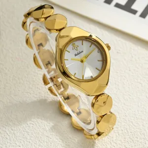 Close-up detail of luxury gold women watch with unique irregular case and circular link bracelet.