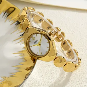Elegant gold women watch detail shot, irregular bezel and link bracelet, chic design.