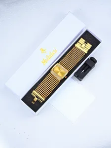 Detailed close-up of luxury gold women's watch in elegant white gift box with adjuster tool.