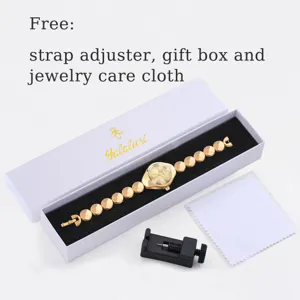 Detailed view of luxury gold quartz watch set with gift box, strap adjuster and cleaning cloth.