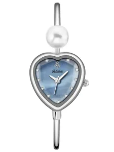 Detailed view of silver bangle watch featuring a heart dial and elegant pearl decoration.