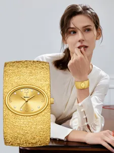 Reloj de mujer de oro de lujo con brazalete texturizado y esfera ovalada elegante.