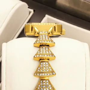 Luxury gold square dial rhinestone women's watch with sparkling crystal stacked bracelet links.
