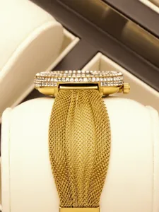 Gold crystal bezel watch detail view, elegant metal mesh strap, luxury women timepiece closeup