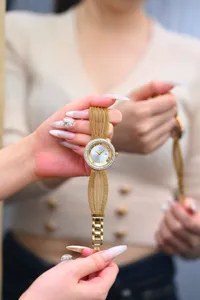Vintage luxury women watch with gold mesh strap and sparkling crystal bezel design.