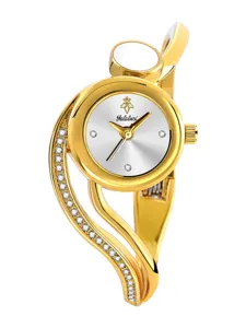 Close-up detail of the luxury gold bangle watch dial with sparkling crystal accents and logo.