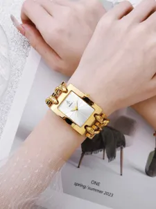 Goldenes quadratisches Zifferblatt mit Kettenglied-Armband, elegante Detailaufnahme am Handgelenk.