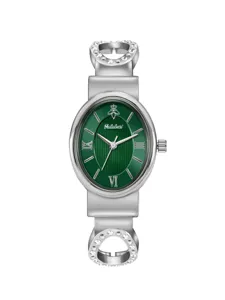 Elegant women's watch detail, oval green dial with rhinestones and silver bracelet strap.