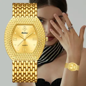 Gold tone quartz watch for women with barrel dial textured bezel and elegant metallic link band.