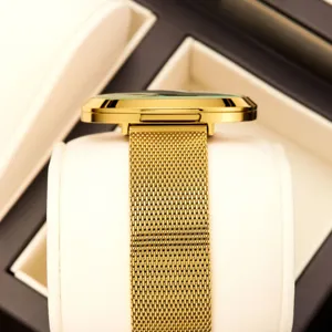 Gold-tone women's quartz watch featuring a sleek mesh strap and elegant profile display.
