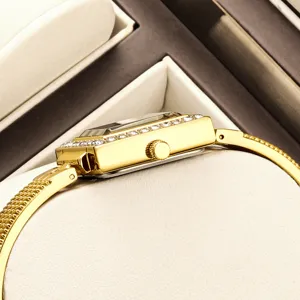 Elegant women's rectangular gold watch with sparkling crystal bezel and sleek metal mesh strap.