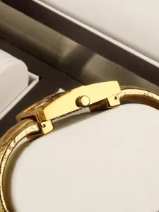 Women gold quartz watch detail view luxury fashion bracelet wristwatch side crown design