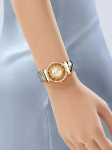 Reloj de cuarzo para mujer con bisel de estrás, esfera calada y correa con estampado de serpiente.