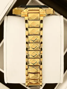 Detail shot of the luxury gold women's watch with diamond bezel and geometric link bracelet.
