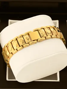 Exquisite gold watch strap featuring geometric faceted links and polished finish for women.
