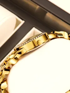 Luxury gold women watch with rhinestone diamond bezel and elegant metal chain strap detail.