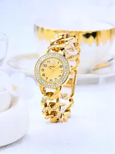 Close-up detail of the dazzling rhinestone bezel and chunky gold chain strap on this watch.
