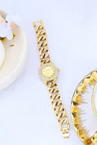 Luxury gold rhinestone chain watch detail closeup, elegant women quartz timepiece display.
