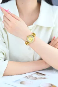 Luxury gold chain watch for women featuring sparkling rhinestone dial and elegant design details.