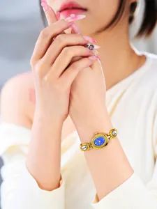 Detailed close-up of a vintage oval blue dial women watch with crystal link bracelet.