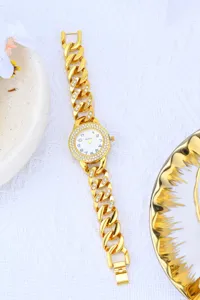 Gold chain rhinestone women watch with sparkling diamond bezel and elegant dial design detail.