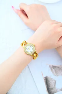 Elegant gold rhinestone chain watch for women, luxury diamond bezel quartz watch.
