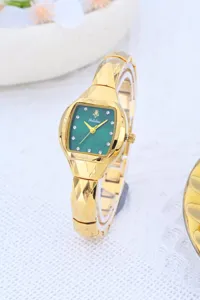 Elegant women's watch with green tonneau dial, rhinestone markers and luxury gold geometric strap.