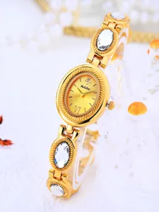 Elegant gold women's watch with oval dial, crystal-encrusted strap, vintage quartz timepiece.