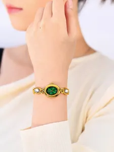 Elegant women's wristwatch featuring a vibrant green dial and gold-tone crystal chain strap.