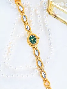 Elegant women's vintage oval green dial quartz watch with crystal chain strap.