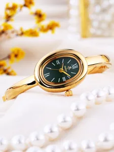 Gold oval quartz watch for women with green dial bangle design elegant fashion timepiece