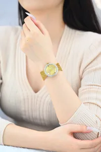 Elegant women watch with crystal encrusted bezel and gold mesh strap luxury design