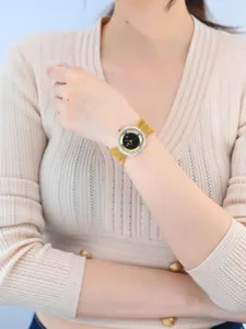 Vintage luxury women watch with rhinestone bezel and gold mesh strap elegant jewelry timepiece.