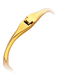 Close up view of the golden metal bangle watch clasp detail, elegant polished finish luxury design.