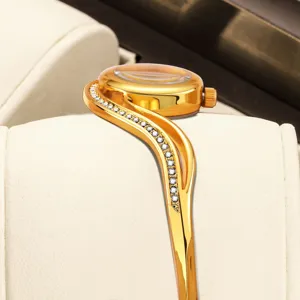 Luxury gold bangle watch for women, elegant crystal bracelet watch with sleek design.