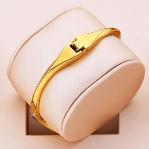 Elegant minimalist gold bangle watch for women, stylish luxury quartz timepiece with sleek design.