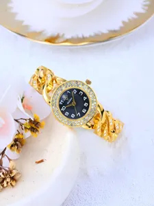 Exquisite luxury gold rhinestone chain women watch detail shot, sparkling crystal bezel dial.