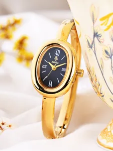 Elegant gold oval bangle watch for women with black dial and classic quartz movement.