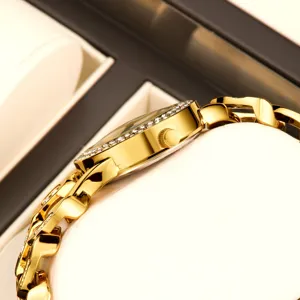 Stunning gold women's watch side view, featuring sparkling rhinestone bezel and strap.