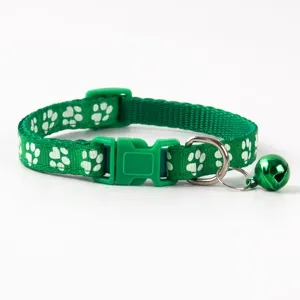 Green pet collar featuring white paw prints, safety quick release buckle, and cute bell detail.