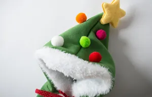Christmas tree pet cloak for cats and dogs with star and colorful pom poms detail shot