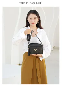 Black quilted shoulder bag detail, featuring metal heart clasp and stylish tassel charm.