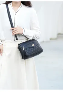 Black quilted crossbody bag with stylish tassel decor and metal M logo, perfect for daily use.