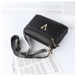 Black quilted crossbody bag for women, stylish shoulder bag with gold V logo and strap.