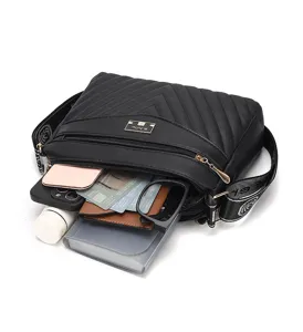 Detail view of the black quilted crossbody bag showcasing spacious interior capacity and strap.
