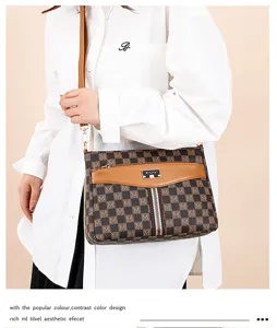 Women stylish brown checkered crossbody bag with adjustable strap and chic front plaque.