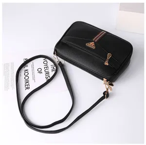 Detailed view of black soft leather women crossbody shoulder bag with stylish metal hardware.